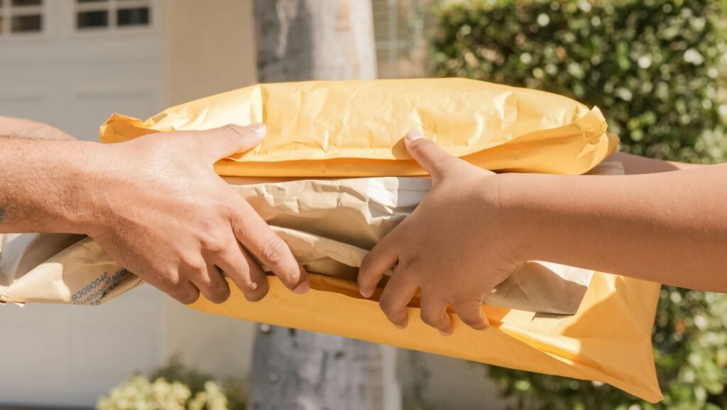 pexels-photo-6994138-6994138 Close-up of two hands exchanging packages, symbolizing delivery and communication.